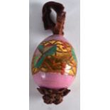 A RUSSIAN PINK PORCELAIN EASTER EGG painted with acorn leaves upon a gilt and pink ground. 3.25ins
