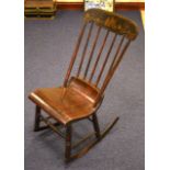 AN EARLY 20TH CENTURY CHINESE INSPIRED ROCKING CHAIR.
