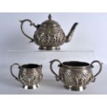 A GOOD LATE 19TH CENTURY INDIAN SILVER THREE PIECE TEASET decorated all over with buddhistic figures