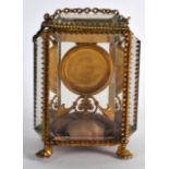 AN EARLY 20TH CENTURY FRENCH FOUR PANEL GLASS AND GILT METAL WATCH HOLDER. 4.75ins high.