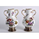 A PAIR OF LATE 19TH CENTURY PORCELAIN SILVER MOUNTED VASES painted with flowers. 2.75ins high.