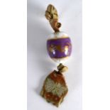 A RUSSIAN PUCE PORCELAIN EASTER EGG painte with gilt acorn leaves upon a central purple ground. 3Ins