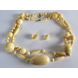 A LARGE 19TH/20TH CENTURY CARVED IVORY NECKLACE with variously carved beads. 89 grams. 2Ft 8ins long