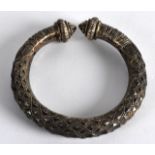 A 19TH CENTURY AFRICAN BANGLE with diamond relief cut decoration. 3.5ins wide.