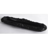 A RARE ANTIQUE VENETIAN BLACK SCROLLING QUILL REST decorated with mask heads. 11.5ins wide.