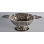 A LOVELY EARLY 19TH CENTURY DUTCH TWIN HANDLED SILVER PORRINGER decorated in relief with scrolling