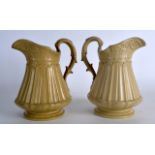 A PAIR OF MID 19TH CENTURY RIDGWAY AND CO POTTERY JUGS with acanthus mounts and scrolling handles.