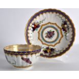 AN 18TH CENTURY WORCESTER RIBBED TEABOWL AND SAUCER painted with fruit and butterflies.