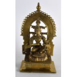 A 16TH/17TH CENTURY INDIAN BRONZE FIGURE OF A BUDDHA inset with ruby eyes, modelled holding a