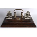 A LATE VICTORIAN/EDWARDIAN GENTLEMANS DESK STAND with silver plated mounts and two inkwells. 1Ft