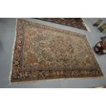 AN EARLY 20TH CENTURY BLUE GROUND PERSIAN RUG. 5 ft 9ins x 4 ft 11ins.