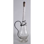 A SLENDER EDWARDIAN DECANTER with white metal scrolling mounts. 1Ft 3.5ins high.