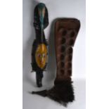 AN UNUSUAL CARVED AFRICAN WOOD MASK together with a gaming board and fly whisk. (3)