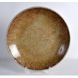 A CHINESE QING DYNASTY CRACKLE GLAZED GE TYPE SAUCER DISH with white lip and mottled brown tones.