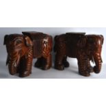 A PAIR OF 19TH CENTURY CHINESE CARVED HARDWOOD FIGURE OF ELEPHANTS boldly modelled in geometric