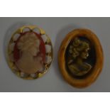 AN UNUSUAL POTTERY CAMEO BROOCH together with another cameo. (2)