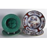 AN UNUSUAL SET OF 19TH CENTURY FRENCH GREEN GLAZED PLATES decorated with landscapes, together with