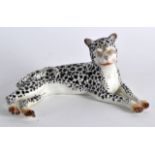 A STAFFORDSHIRE FIGURE OF A RECUMBANT SPOTTED LEOPARD. 4.5ins wide.