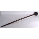 A GOOD LATE 19TH CENTURY CARVED TRIBAL CLUB with heavy stone terminal and shell mounts. 4ft long.