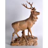 A LATE 19TH/20TH CENTURY BAVARIAN CARVED FIGURE OF A STAG modelled in a roaming stance upon a