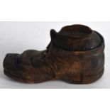 AN EARLY 20TH CENTURY CARVED WOOD NOVELTY INKWELL in the form of a boot. 5Ins wide.