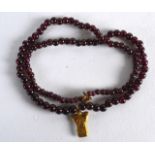 A 9CT GOLD MOUNTED GARNET NECKLACE set with an early high carat gold pendant. 1Ft 6ins long