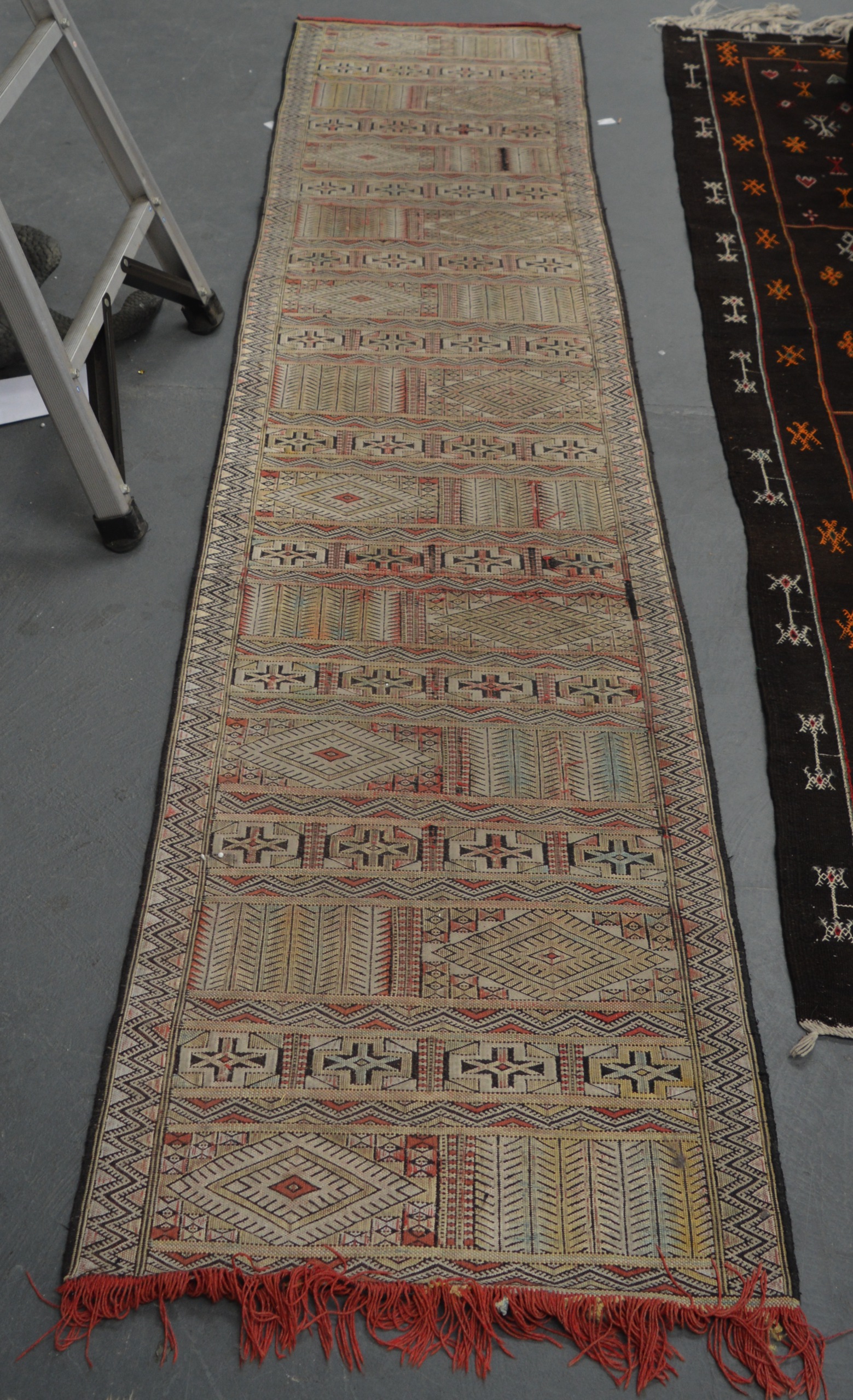 A MID 20TH CENTURY SOUMAC RUNNER, decorated with motifs.