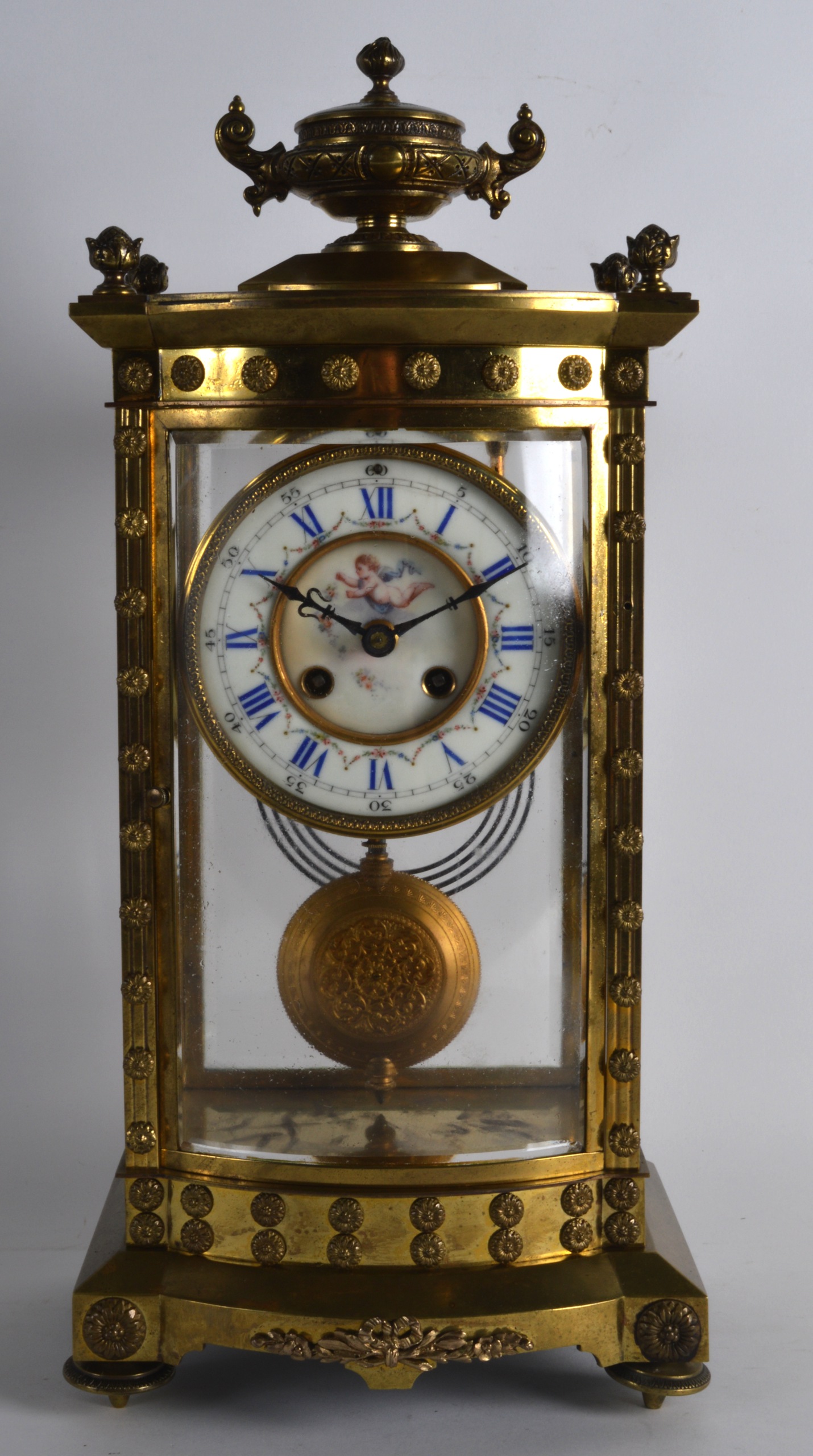 AN EARLY 20TH CENTURY FRENCH BRONZE AND PORCELAIN MANTEL CLOCK the dial painted with swags and putti