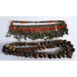 A VERY EARLY CARVED MULTI BEAD NECKLACE with circular and square cut beads, together with a late