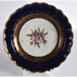 AN 18TH CENTURY WORCESTER BLUE GROUND PLATE painted with flowers. 7.5ins diameter.