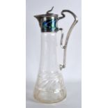 AN ART NOUVEAU SILVER PLATED AND ENAMEL DECANTER with scrolling floral motifs. 11.5ins high.