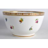 A 19TH CENTURY FRENCH PORCELAIN BOWL painted with floral sprays under a gilt border. 6.5ins