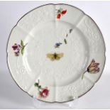 AN 18TH CENTURY CHELSEA FINE MOULDED PLATE painted with a butterfly. 9.5ins diameter.