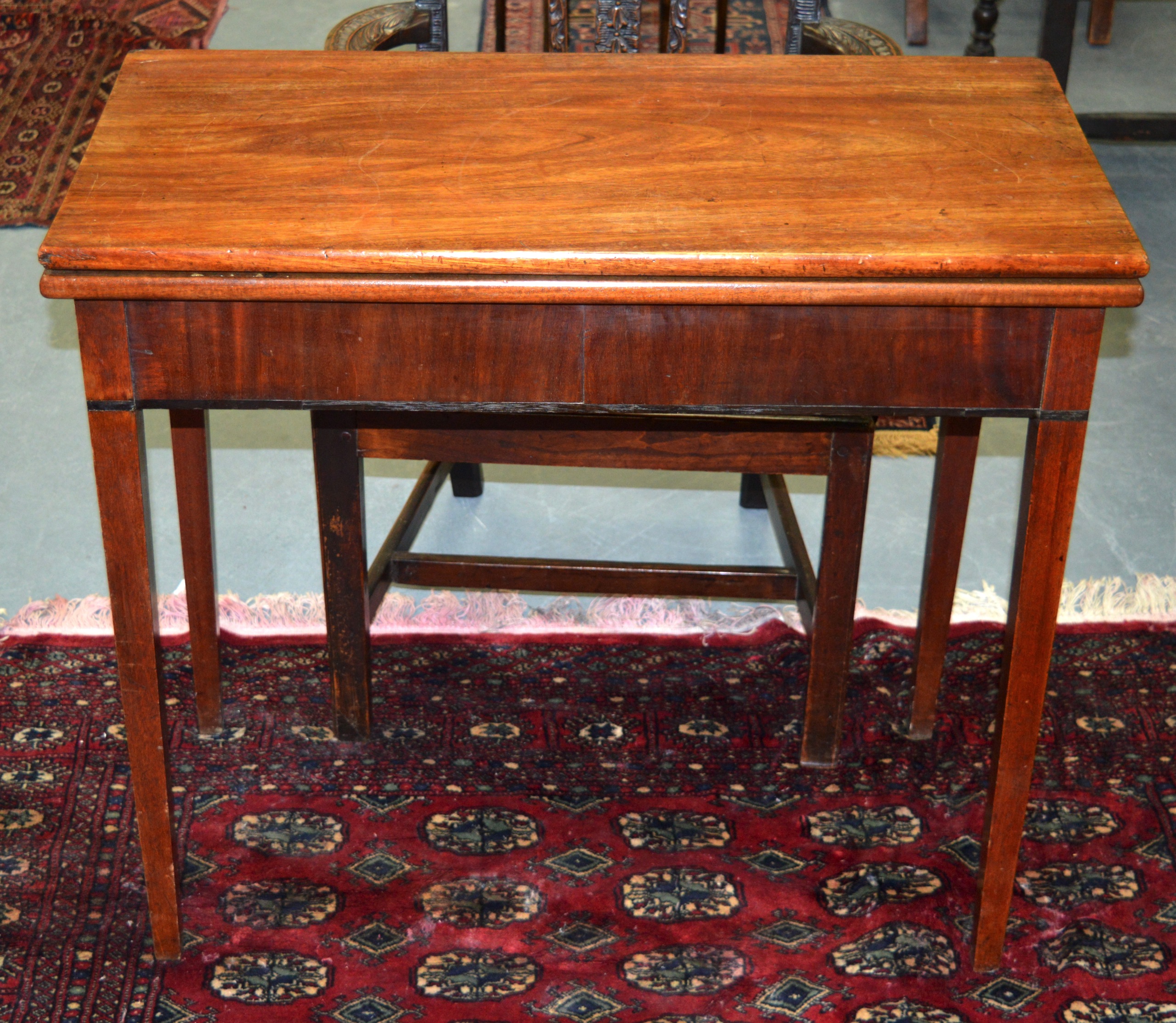 A MID 19TH CENTURY MAHOGANY FOLD OVER CARD TABLE.