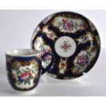 AN 18TH CENTURY WORCESTER BLUE SCALE COFFEE CUP AND SAUCER painted with English flowers.