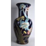 A LARGE ART NOUVEAU STYLE POTTERY VASE decorated with stylised flowers and vines. 2Ft 1ins high.