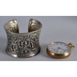 A CONTINENTAL LADIES SILVER REPOUSSE BANGLE together with a rolled gold watch. (2)