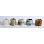 A COLLECTION OF FIVE EARLY 20TH CENTURY CHINESE JADE ARCHERS RINGS of various forms and sizes. (5)