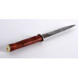 AN UNUSUAL EARLY 20TH CENTURY CARVE CORAL AND SHELL KNIFE with steel blade. 10Ins long.