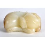 AN EARLY 20TH CENTURY CHINESE CARVED WHITE JADE FIGURE OF A BULLOCK modelled recumbant with its head