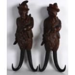 A PAIR OF LATE 19TH CENTURY BAVARIAN BLACK FOREST COAT HOOKS signed R Heinfall, in the form of