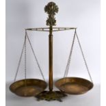 A LARGE PAIR OF VICTORIAN BRASS SCALES decorated with acanthus and other motifs. 2ft high.