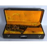 A VINTAGE PARROT BRASS SAXOPHONE engraved with stylised motifs, in original box. 1ft 9ins long.