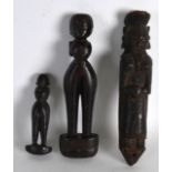 AN UNUSUAL GROUP OF THREE 19TH CENTURY CARVED HARDWOOD FIGURES possibly African, of various sizes.