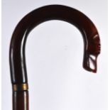 AN UNUSUAL CARVED HORN HOUND HEAD WALKING CANE with large scrolling terminal. 3ft long.