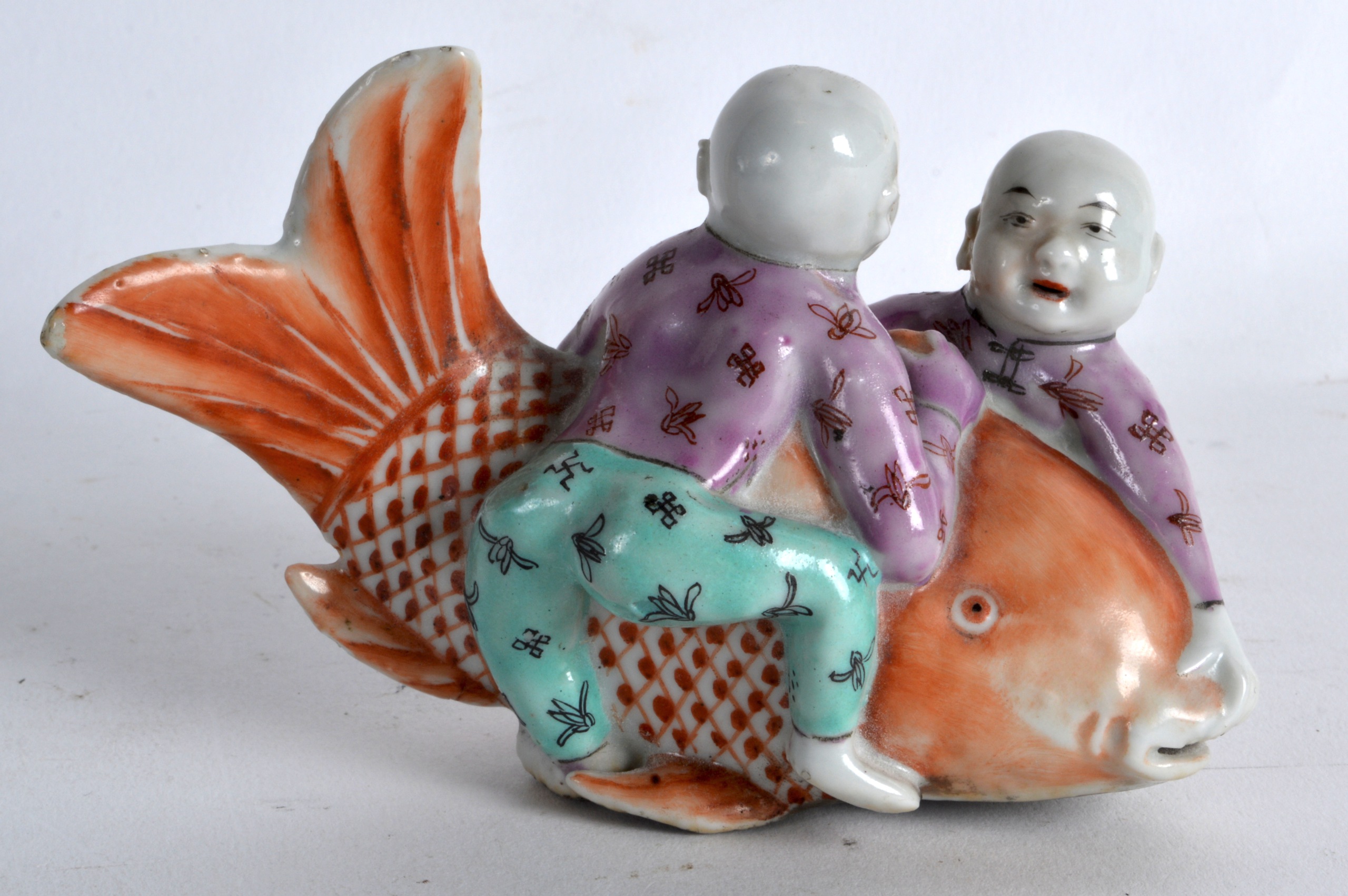 AN UNUSUAL 19TH CENTURY CHINESE FAMILLE ROSE FIGURE OF A TWO BOYS modelled holding a large carp. 4.