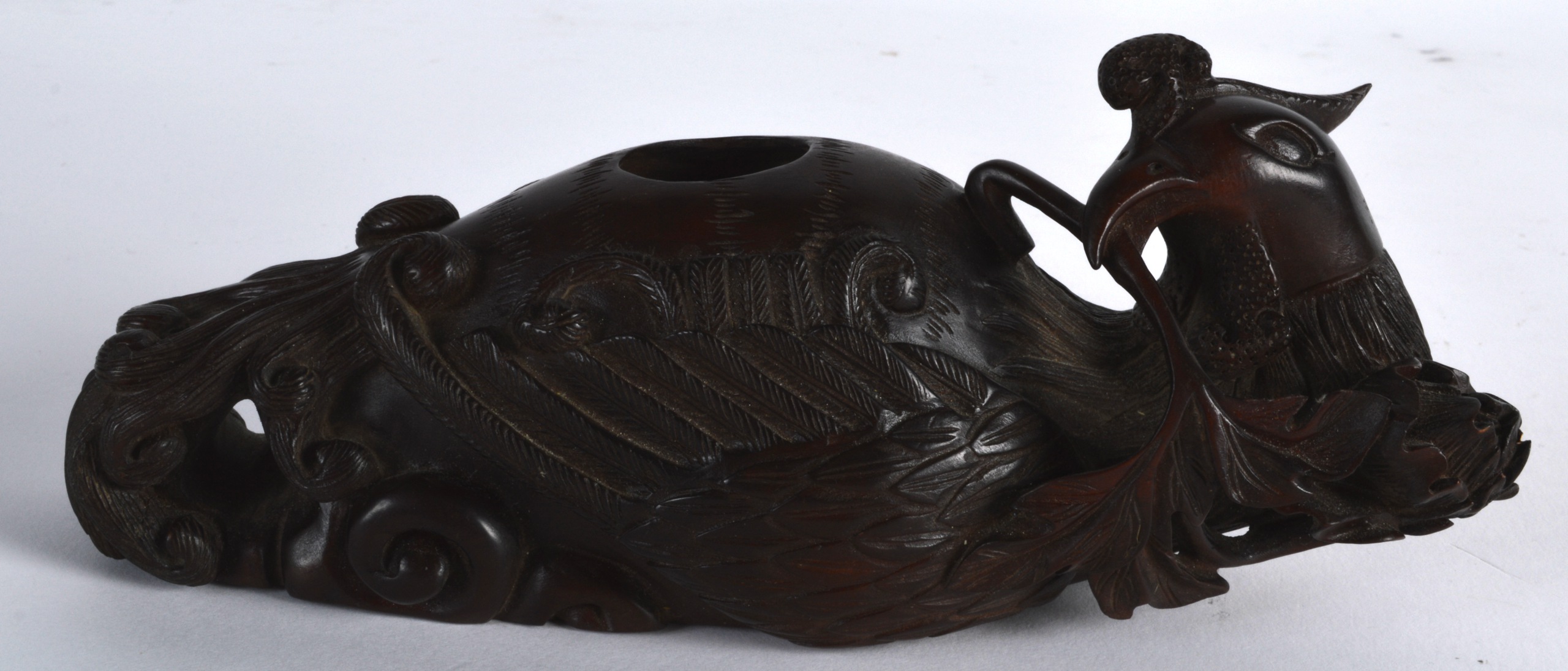 AN EARLY 20TH CENTURY CARVED HARDWOOD BRUSH WASHER Qing/Republic, modelled as a hoho bird holding