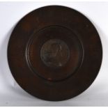 AN EARLY 20TH CENTURY COPPER TRAY inset with a bronze medallion. 8.5ins diameter.