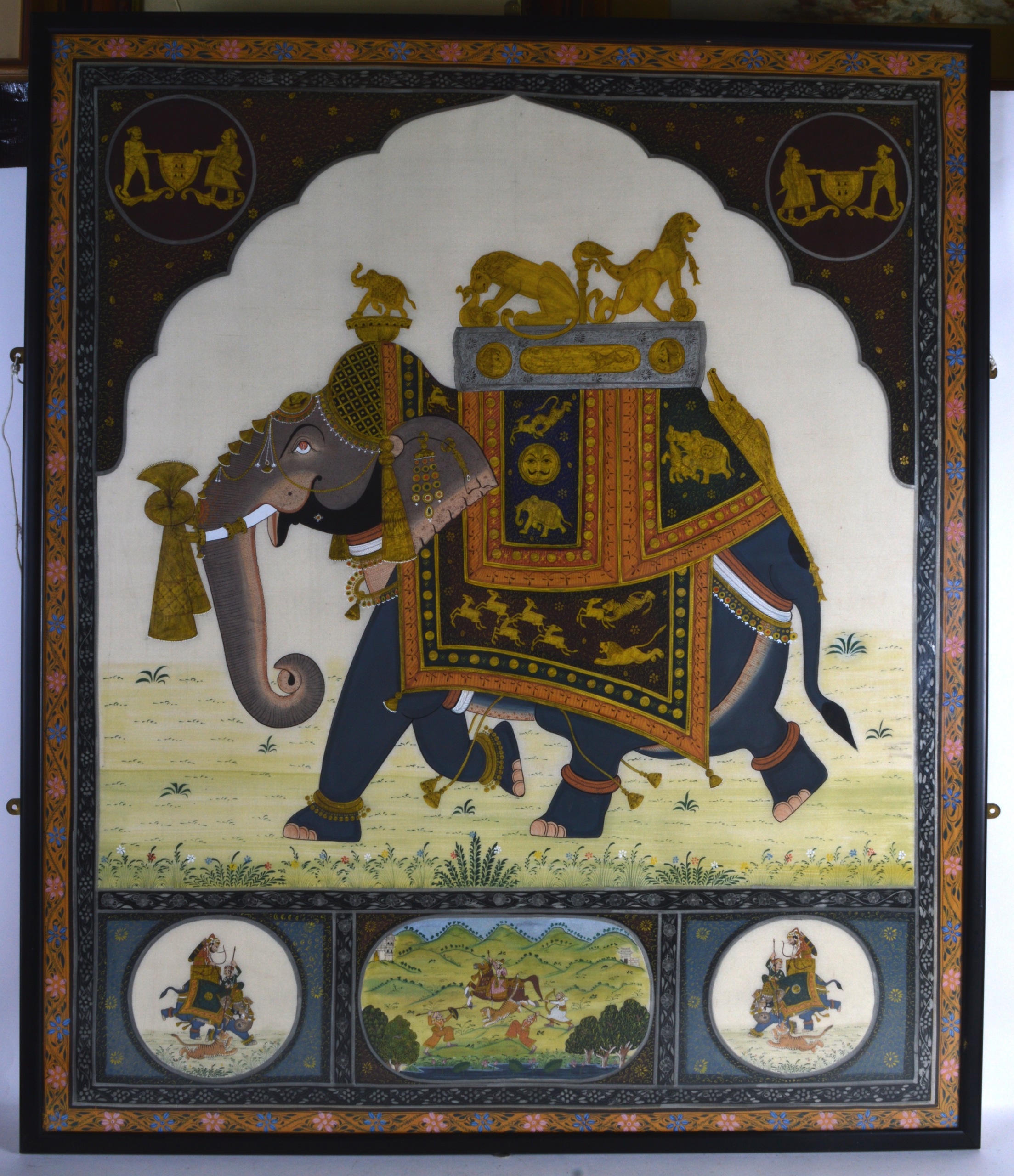 A LARGE MUGHAL SCHOOL FRAMED SILKWORK PANEL depicting various Buddhistic symbology, the central