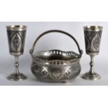 A LATE 19TH CENTURY RUSSIAN SILVER NIELLO SUGAR BASKET with matching goblets. (3)